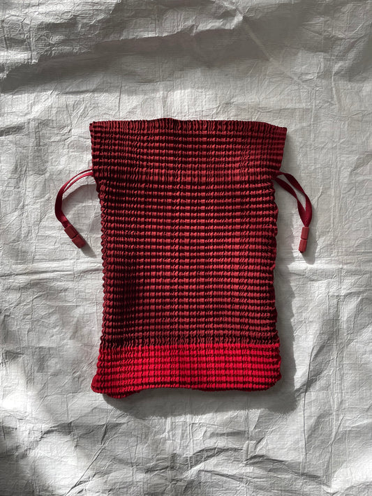 Issey Miyake red drawstring bag