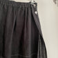 Detail view of womens vintage Issey Miyake black skirt with white contrast stitch