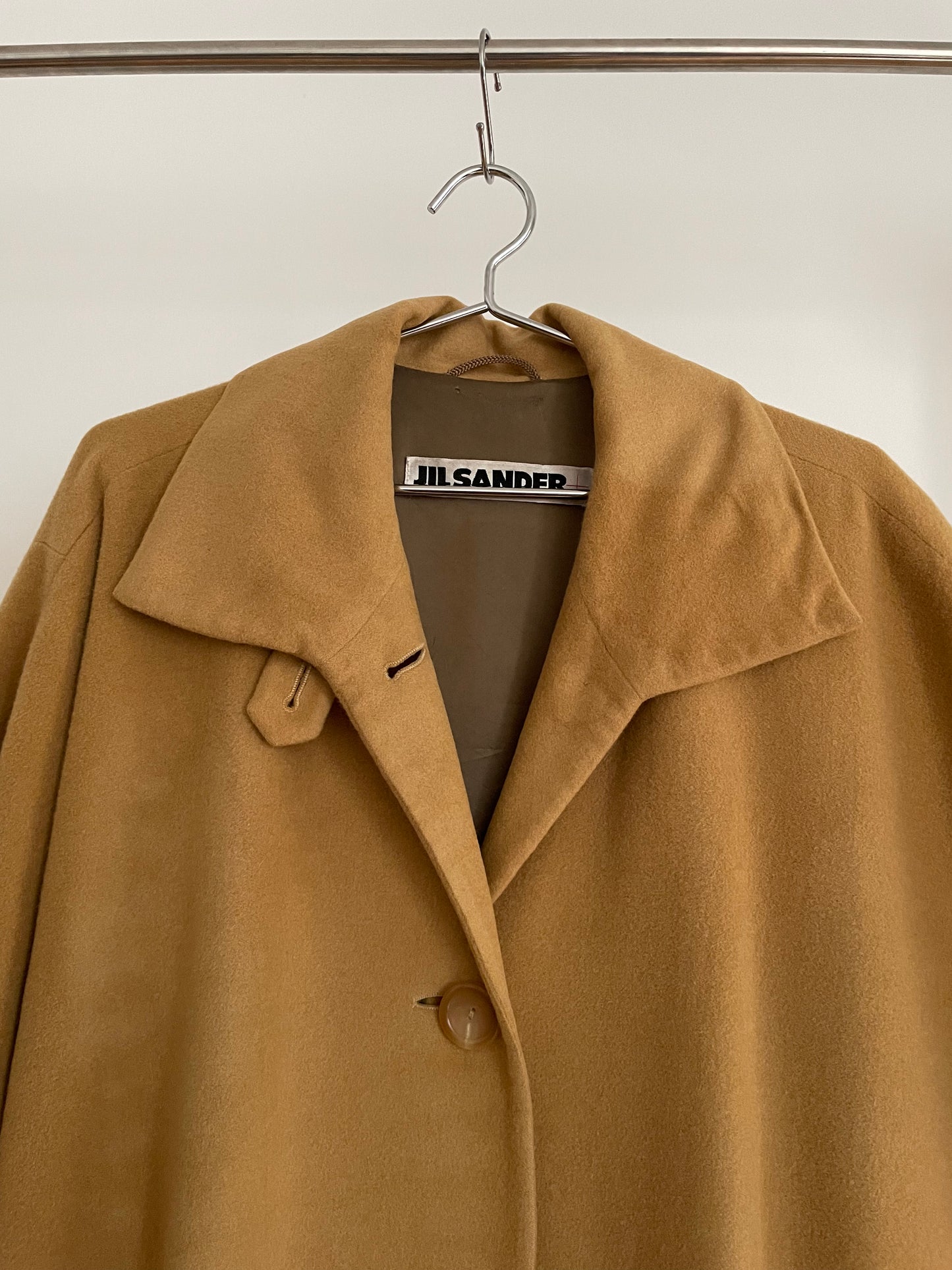 Detail view of vintage womens Jil Sander 1980s camel dolman sleeve coat