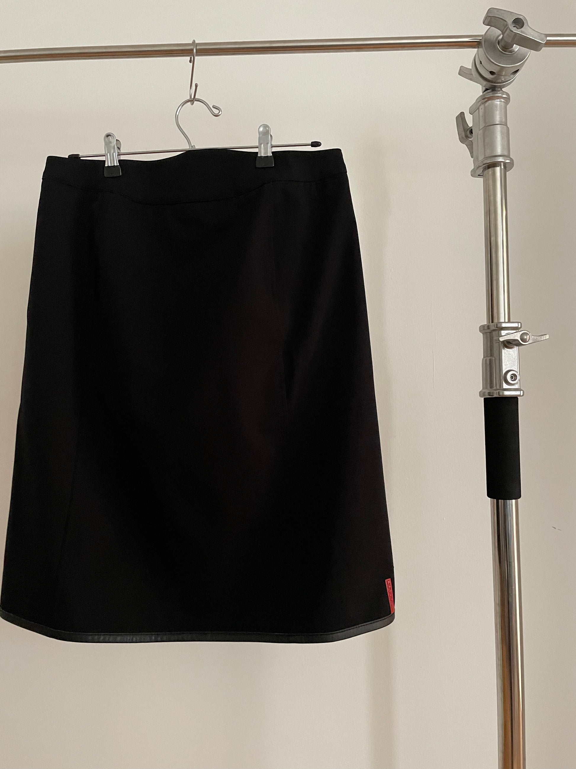 Back view of vintage womens Prada Sport black skirt with zippers