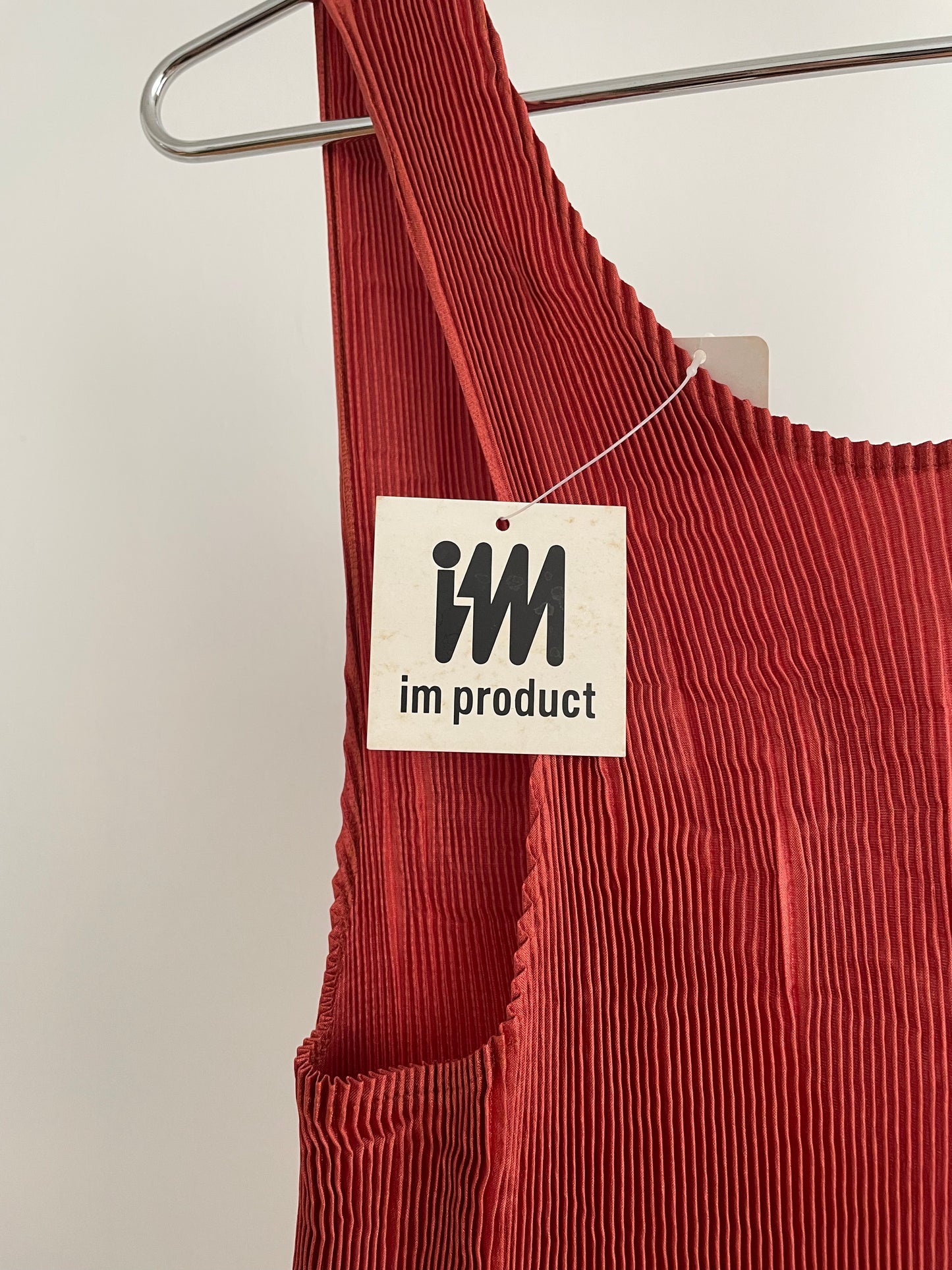 Detail view of vintage IM Product red pleated apron dress