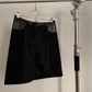 Front view of vintage womens black Prada skirt in nylon and neoprene with leather details