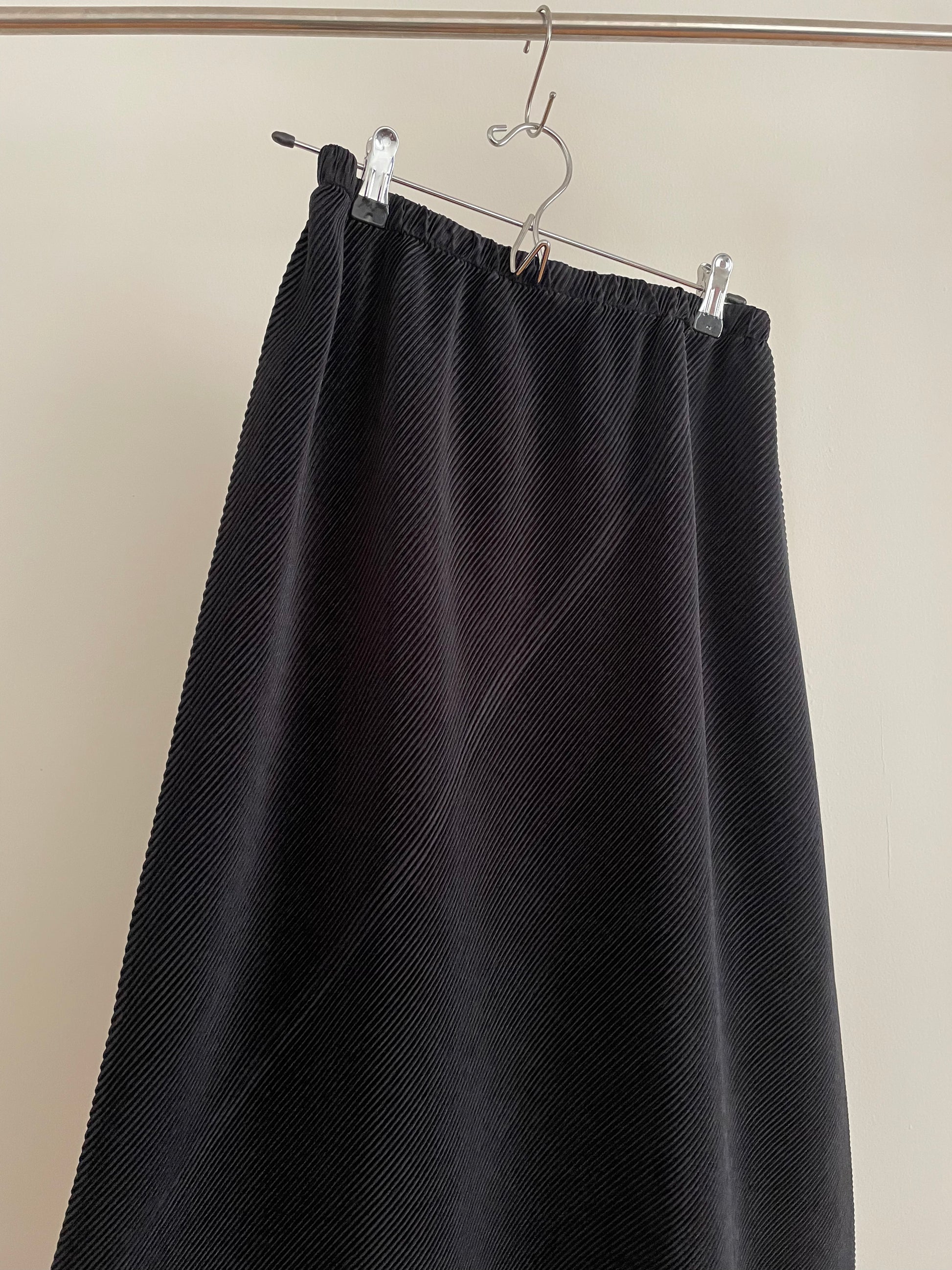 Detail of vintage womens Issey Miyake black asymmetric pleated skirt