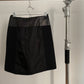 Back view of vintage womens black Prada skirt in nylon and neoprene with leather details