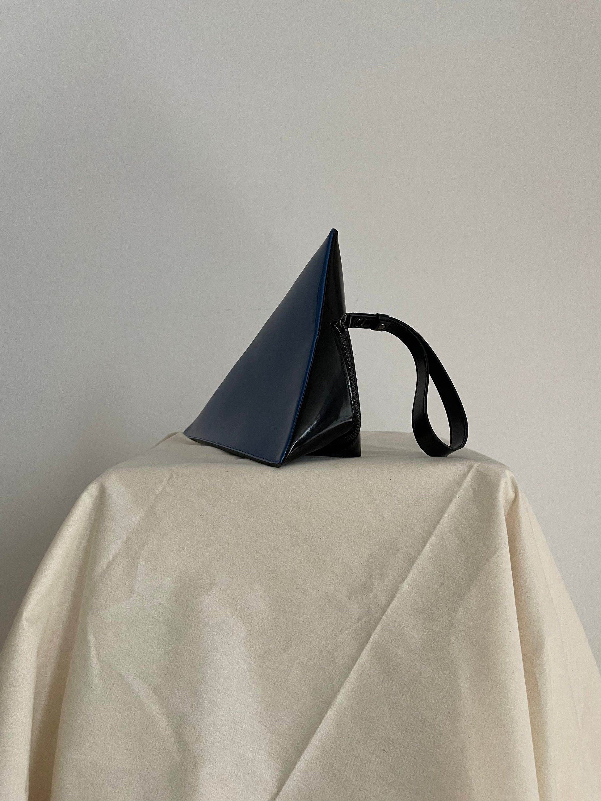Issey Miyake blue and black triangle clutch with strap
