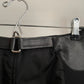Detail view of vintage womens black Prada skirt in nylon and neoprene with leather details