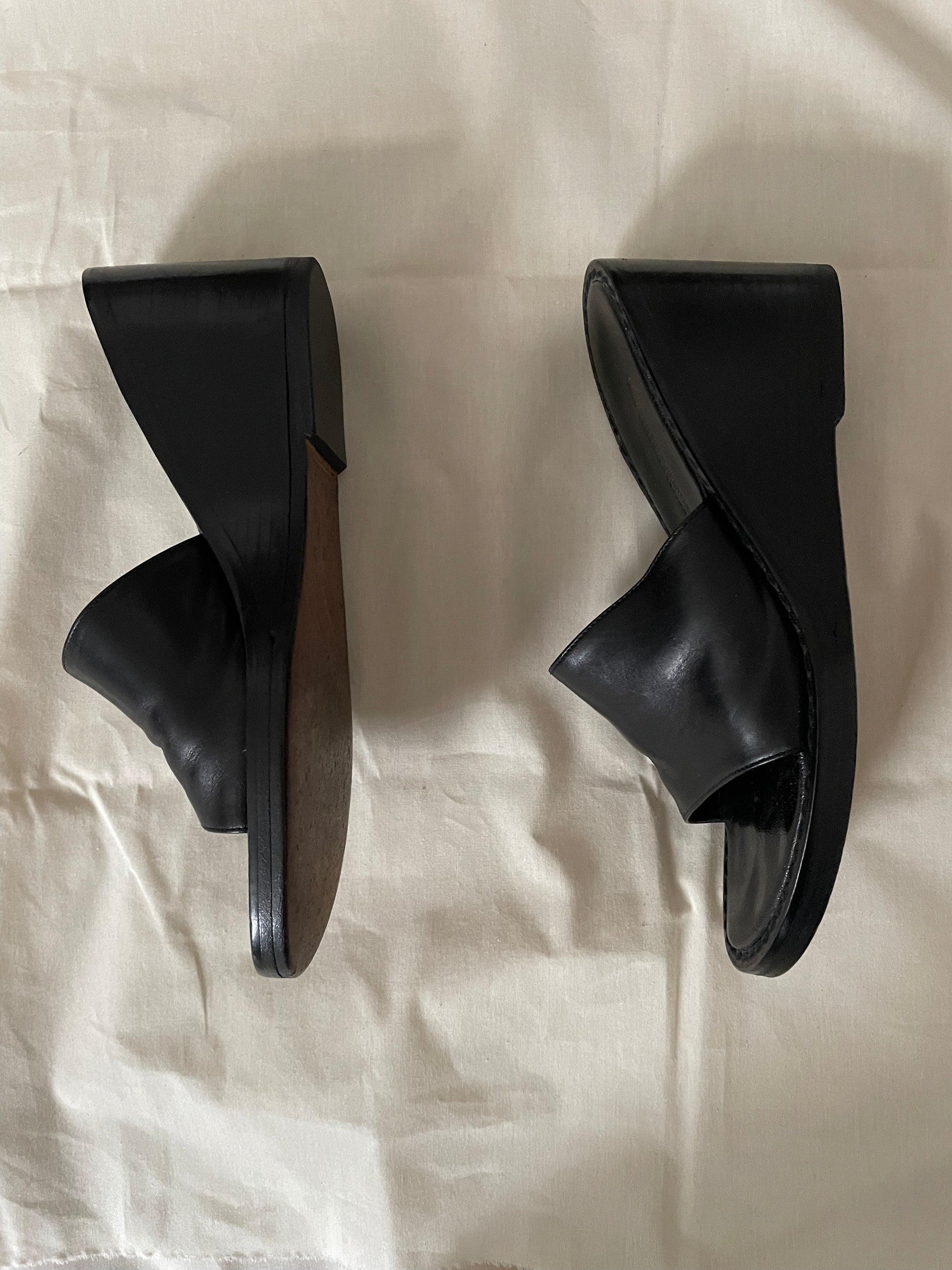 Side view of womens black Ann Demeulemeester wedge sandals