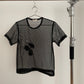 Front view of vintage womens Comme des Garçons black short sleeve mesh top with rosette appliqués