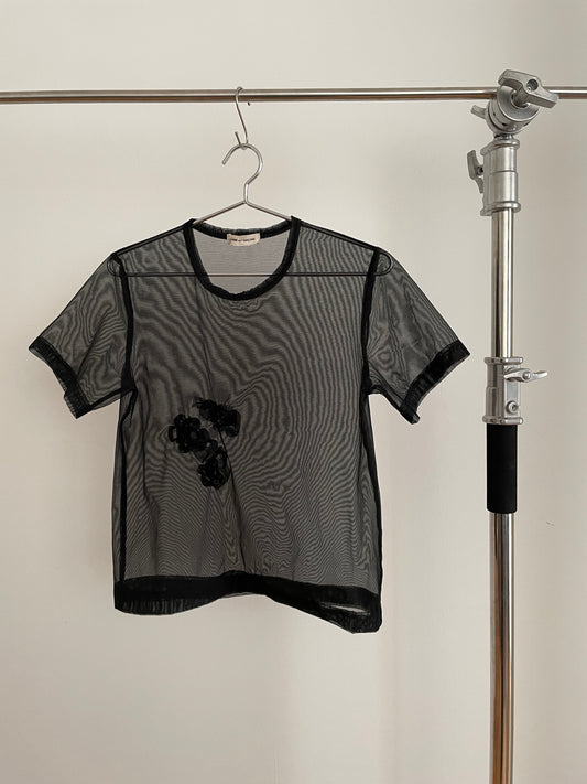 Front view of vintage womens Comme des Garçons black short sleeve mesh top with rosette appliqués