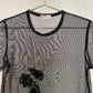 Detail view of vintage womens Comme des Garçons black short sleeve mesh top with rosette appliqués
