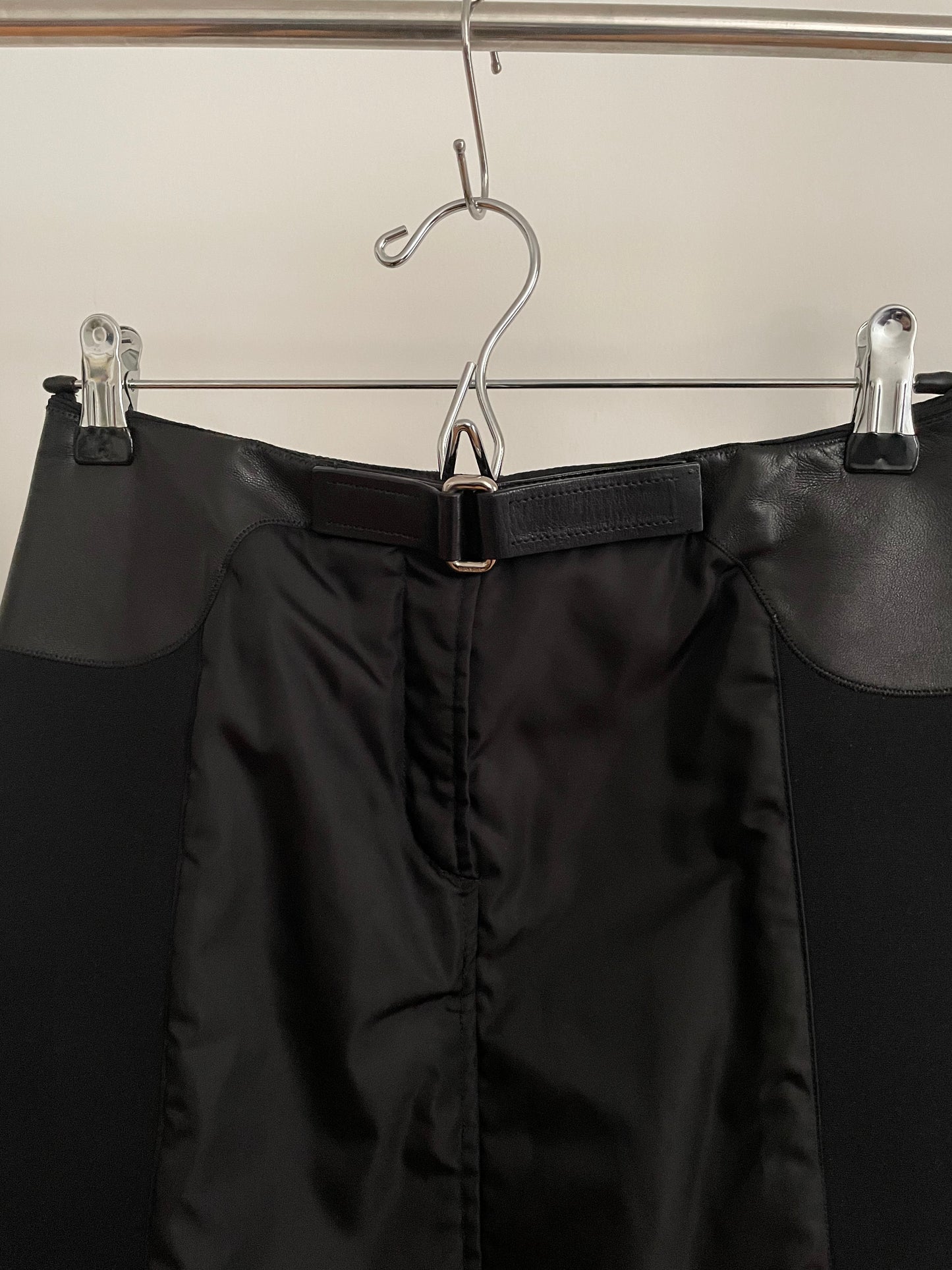 Detail view of vintage womens black Prada skirt in nylon and neoprene with leather details